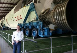 man posing outside of shuttle