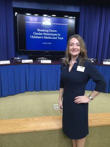 woman posing in front of presentation