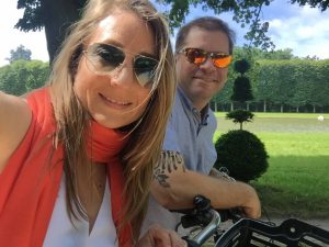 man and woman posing outdoors in sunglasses