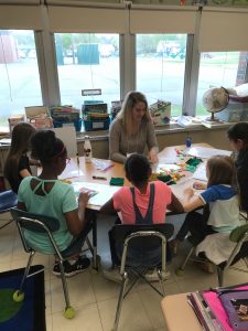 woman instructing classroom of young children