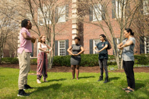 group outside with hands clasped in front of them